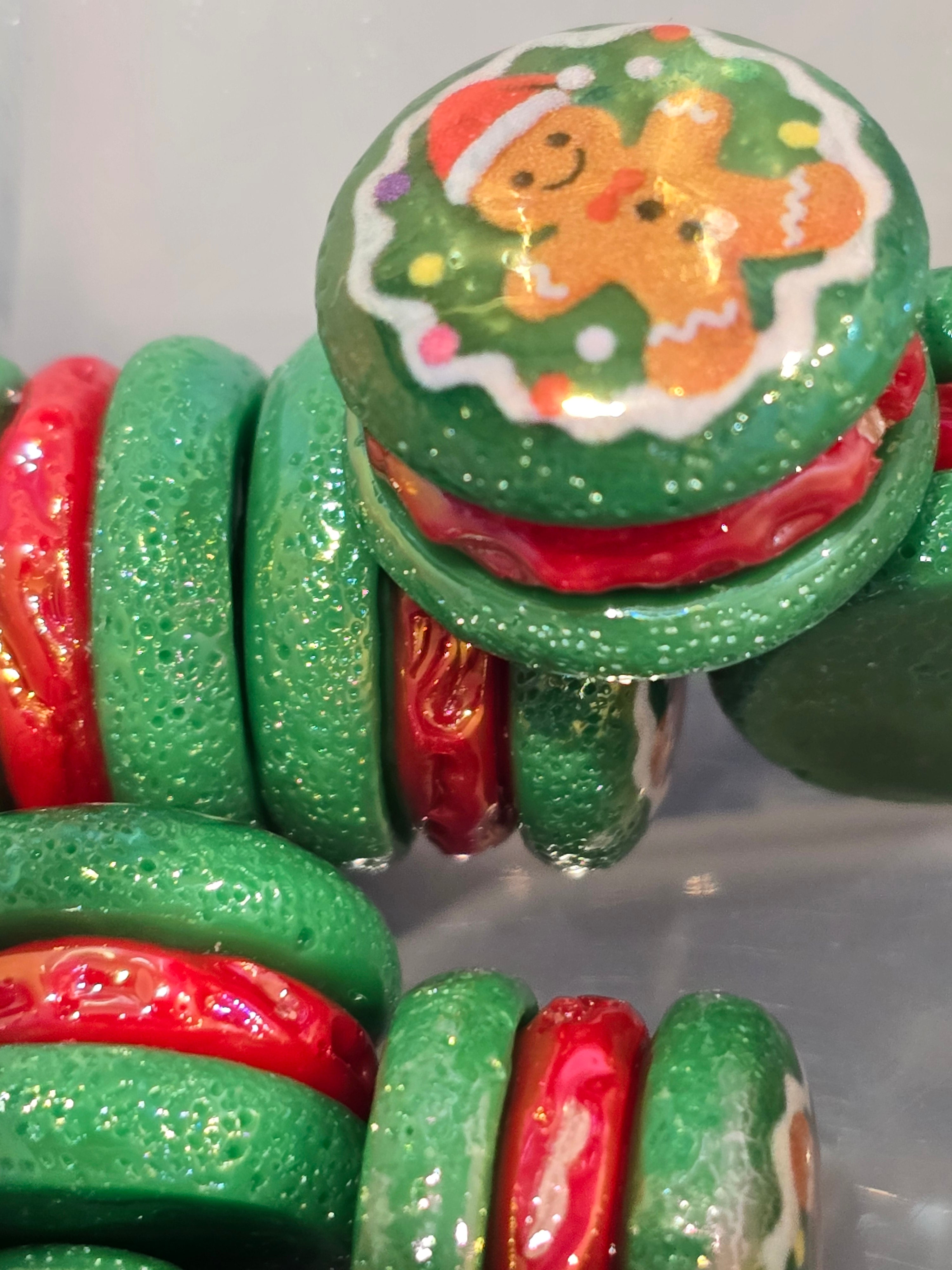 "Green glitter resin Christmas cookie bead with gingerbread man and Christmas wreath design"