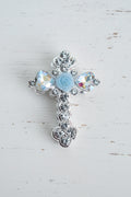 A silver-toned cross-shaped bead embellished with clear rhinestones, a rose and iridescent glass heart-shaped crystals.