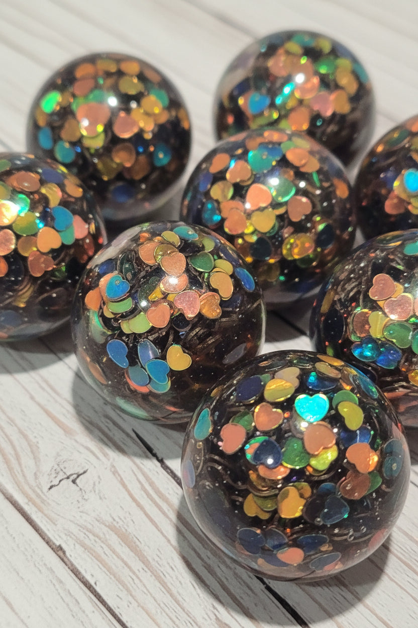 Resin top hole beads filled with iridescent heart-shaped confetti.