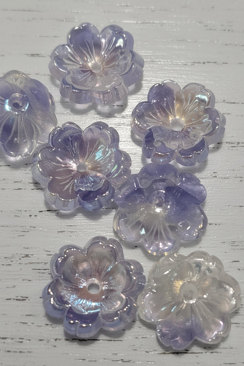 Several translucent flower-shaped beads with a lavender and iridescent finish.