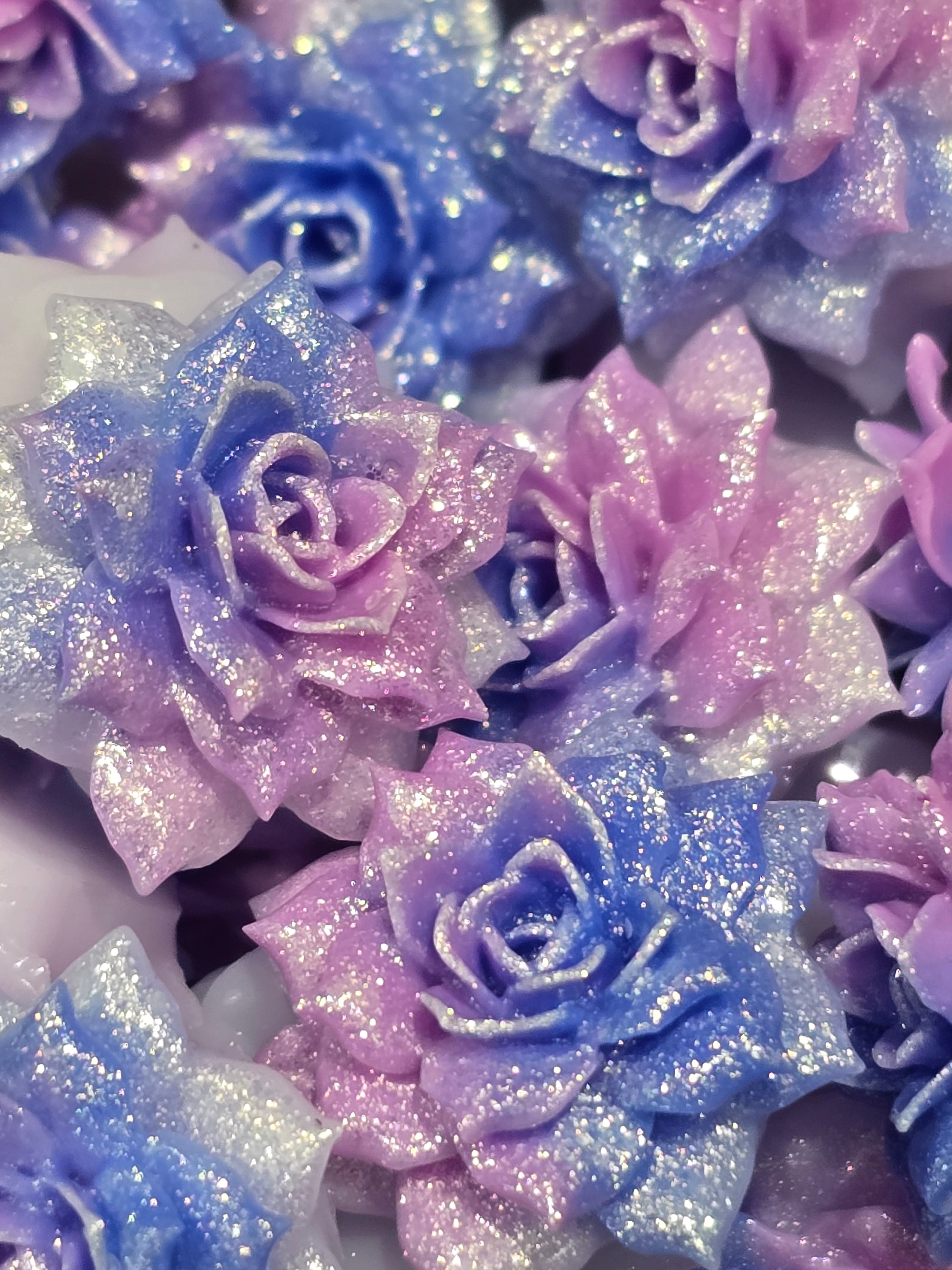 Soft flowers in pastel purple, blue, and silver tones.