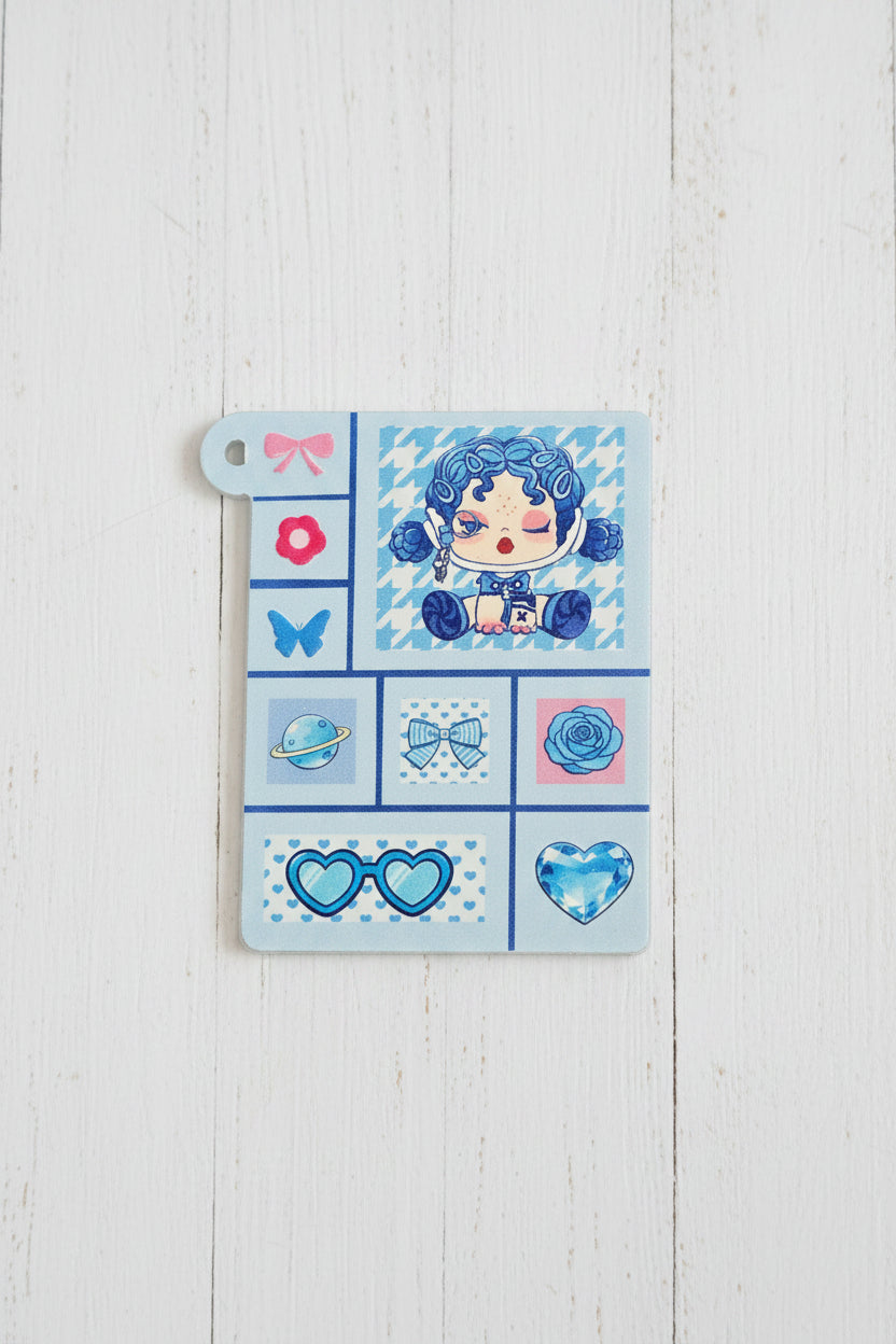 A rectangular acrylic tag featuring a blue and pink anime-style character illustration and various blue-themed icons.
