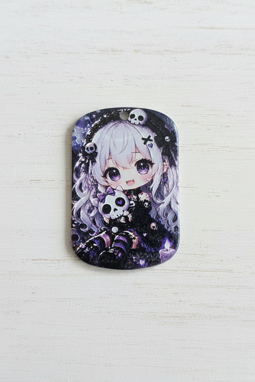 A rectangular metal tag with rounded corners featuring a detailed anime-style illustration of a girl with white hair, purple eyes, skulls, and dark gothic patterns.
