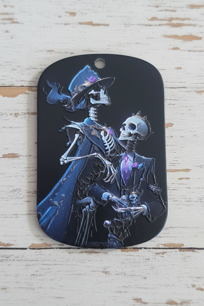 An acrylic tag featuring a detailed graphic of two skeletons in dark robes.