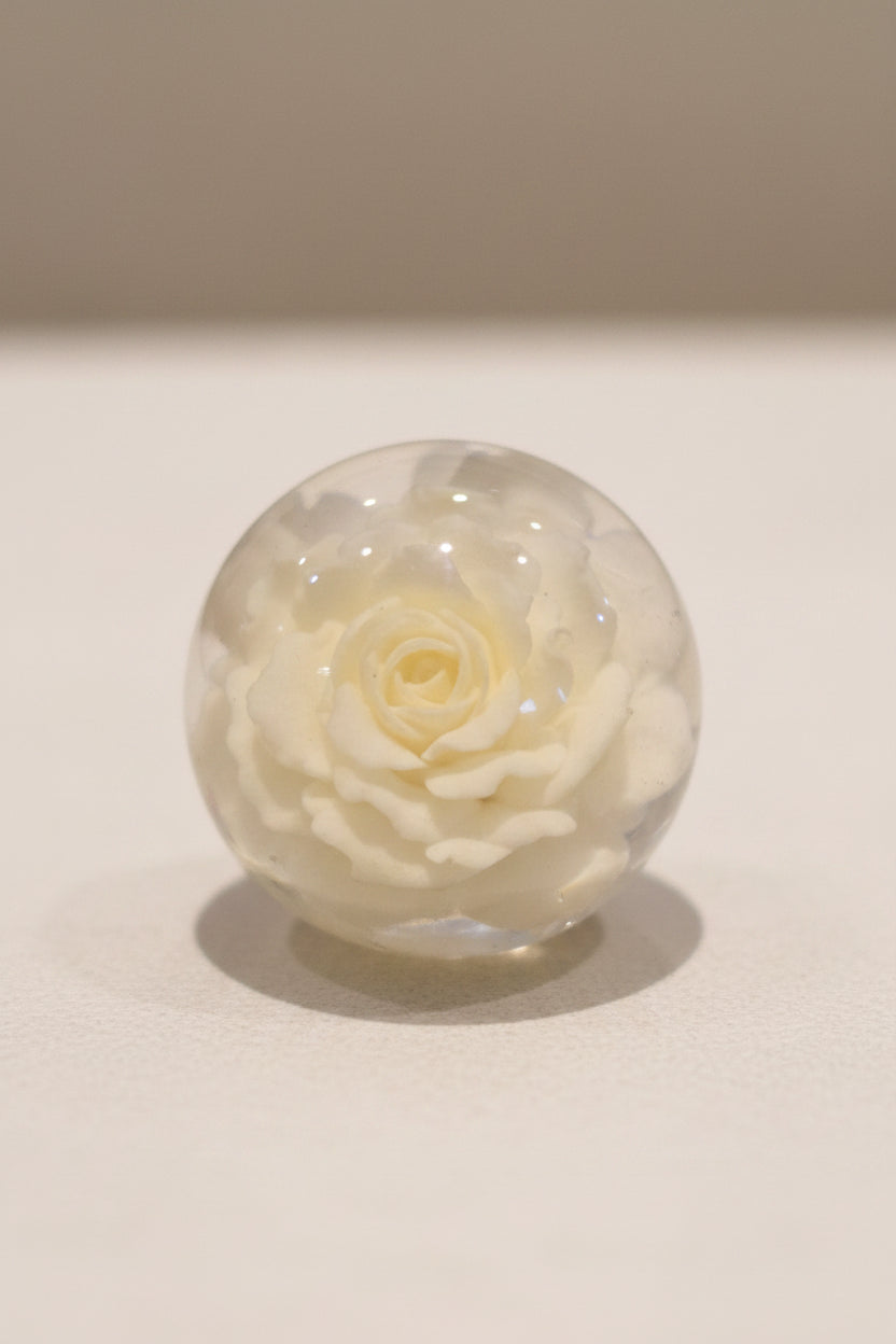 25mm top hole clear round resin top bead containing a preserved pale white rose.