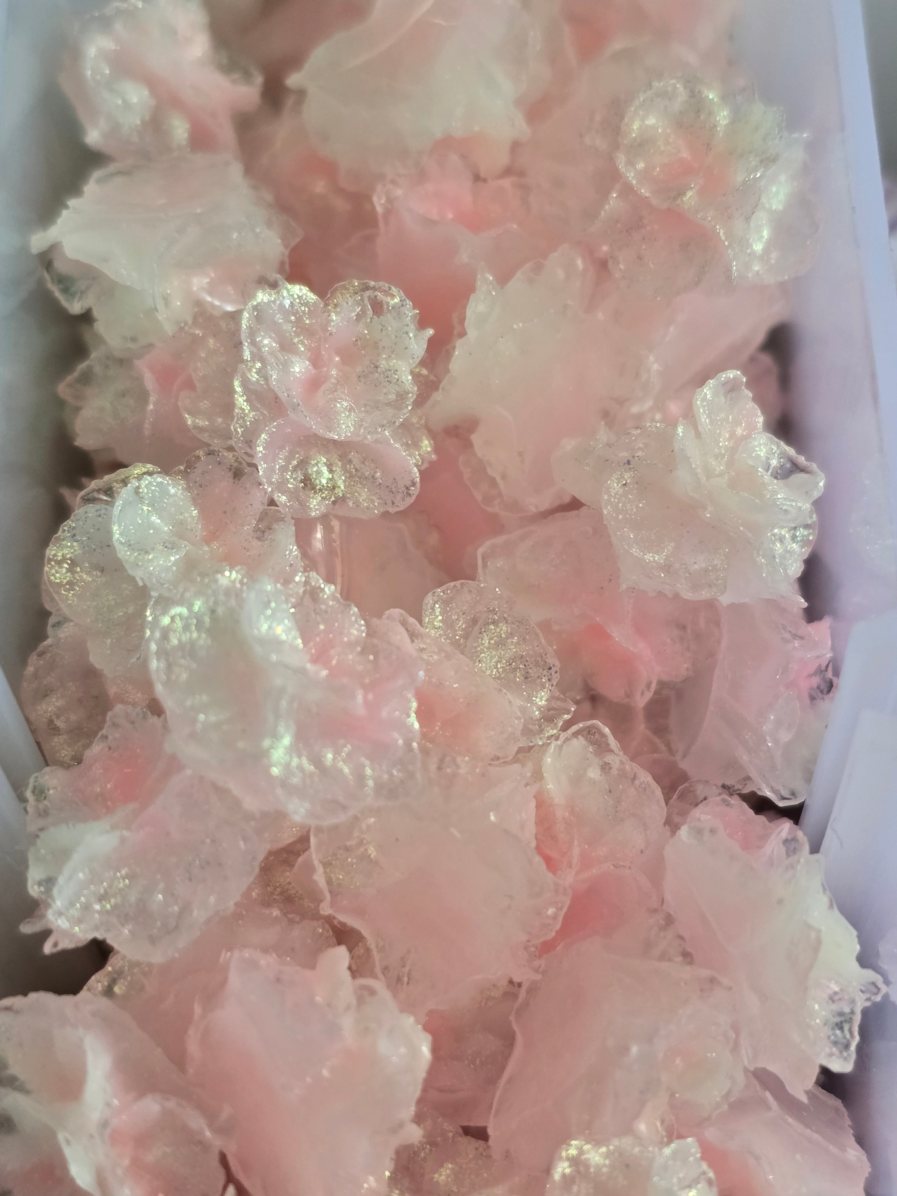 A close-up of multiple light pink illuminous soft flowers