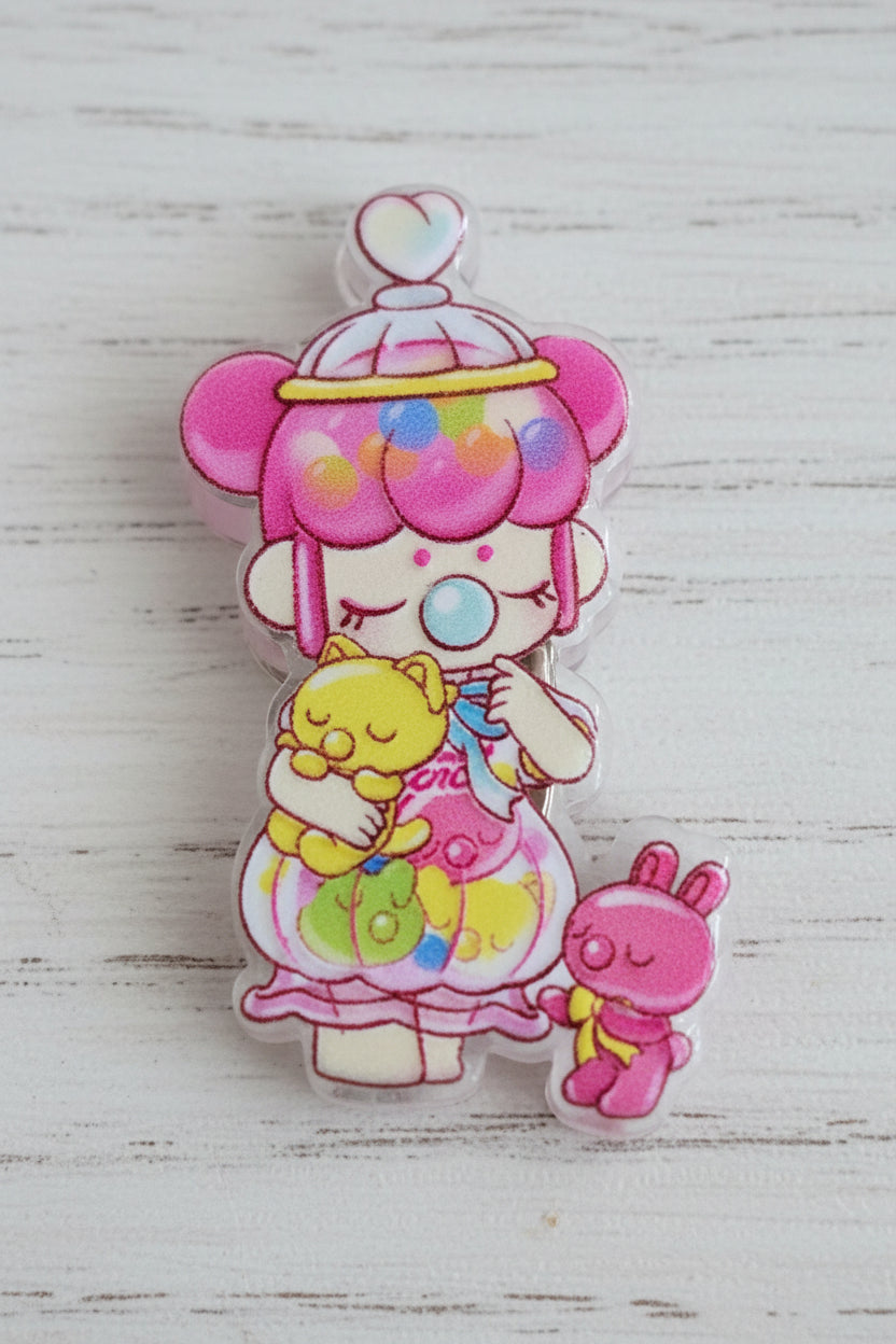 A colorful acrylic focal bead featuring a cute anime-style character with pink hair, holding a yellow cat.