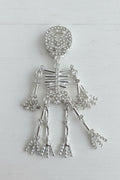 A silver skeleton-shaped bead covered with clear rhinestones.