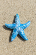 A glossy blue starfish-shaped acrylic pendant with a textured, bubbly pattern.