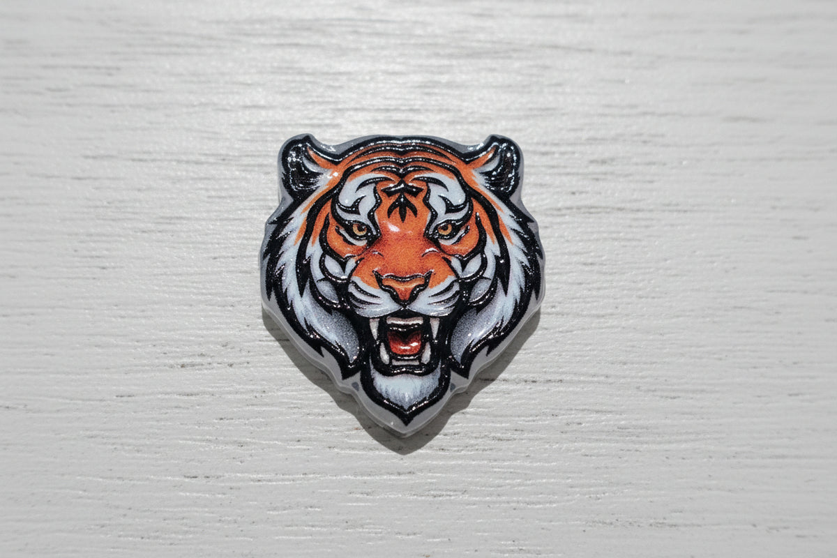 A tiger head acrylic bead with orange, white.