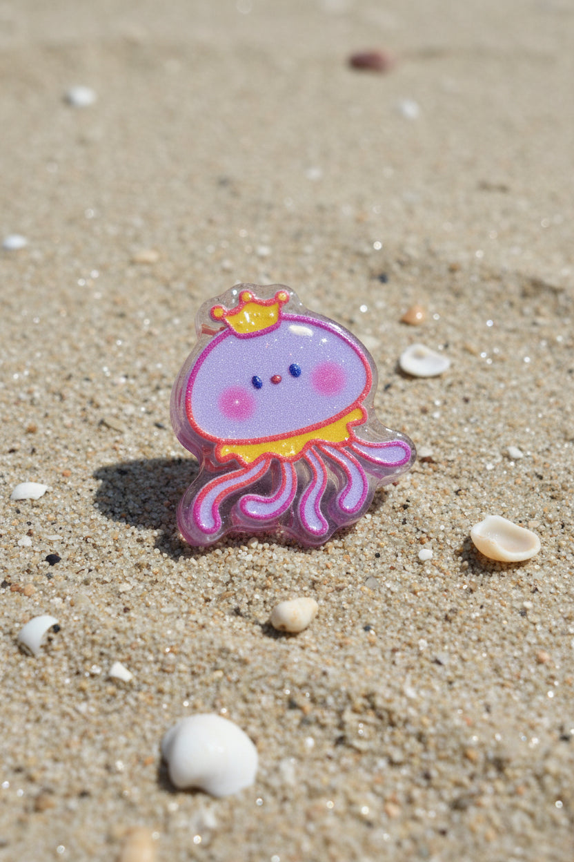 A small jellyfish-shaped accessory with a purple body, pink tentacles, a yellow crown, and blue eyes.