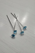 Silver pins with blue zircon