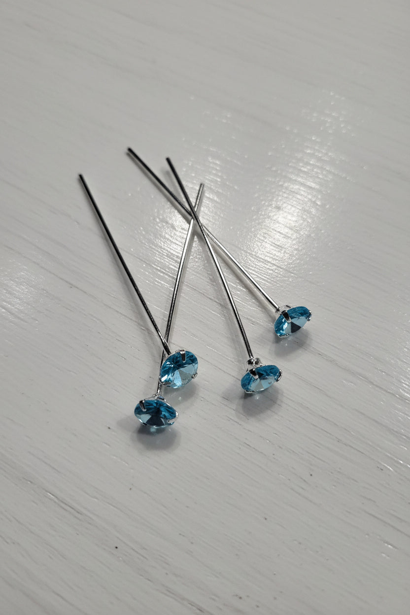 Silver pins with blue zircon