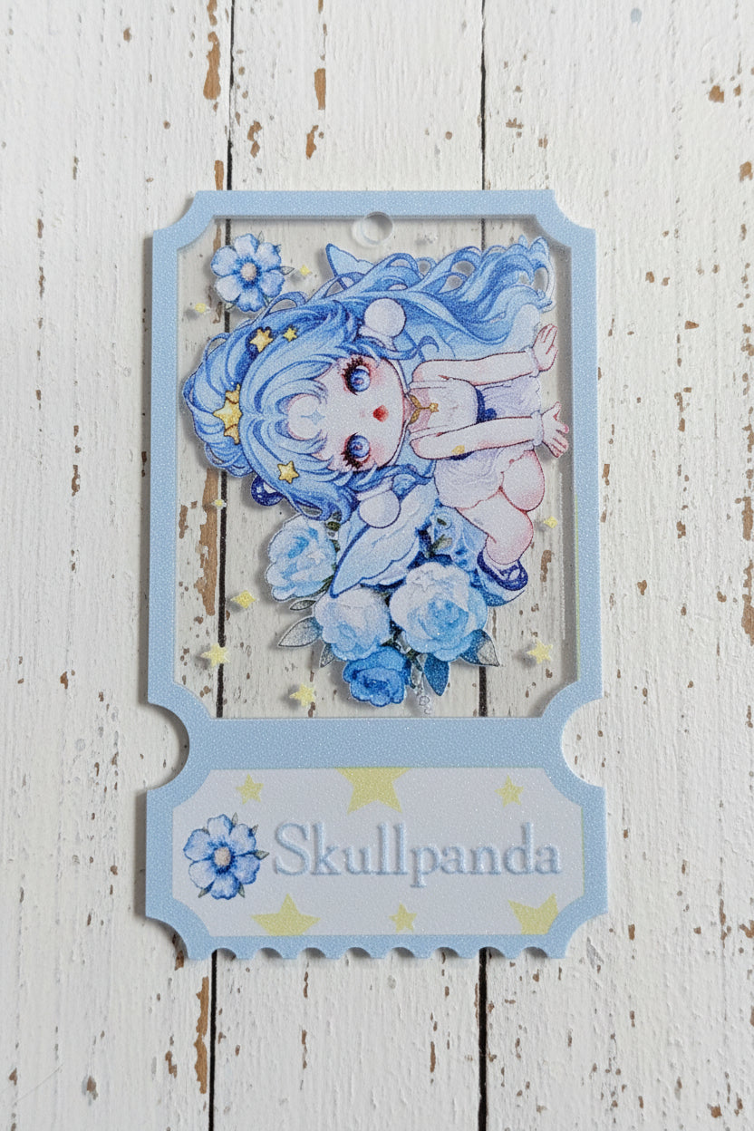 A decorative hanging tag owith a printed anime-style illustration of a blue-haired character surrounded by flowers, mounted on a scalloped white-and-blue base labeled 'Skullpanda,'.