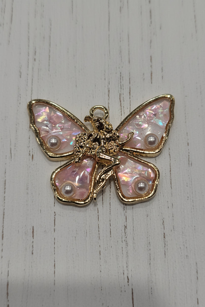 A butterfly-shaped jewelry charm featuring iridescent pink mother-of-pearl wings with small pearl accents and a gold-tone metal body and borders.