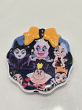 A scalloped-edge bead bearing a colorful printed design of Disney's Maleficent and other classic princess characters on a dark background, with a large orange bow at the top.