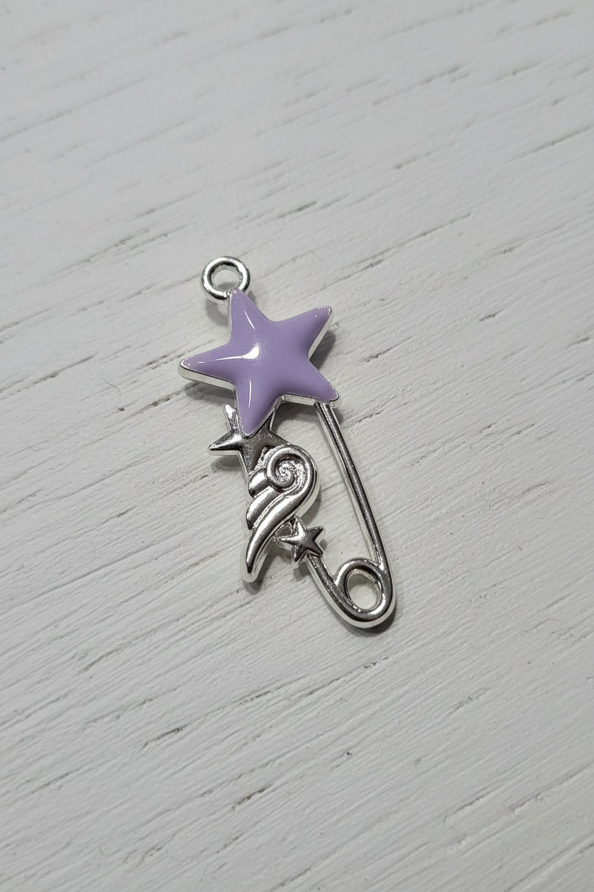 A silver safety pin charm designed as a shooting star, featuring a lavender purple star head and a silver safety pin body.