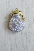 A Santa Claus face pendant with an iridescent, pearlescent white beard and a gold-tone hat and border.