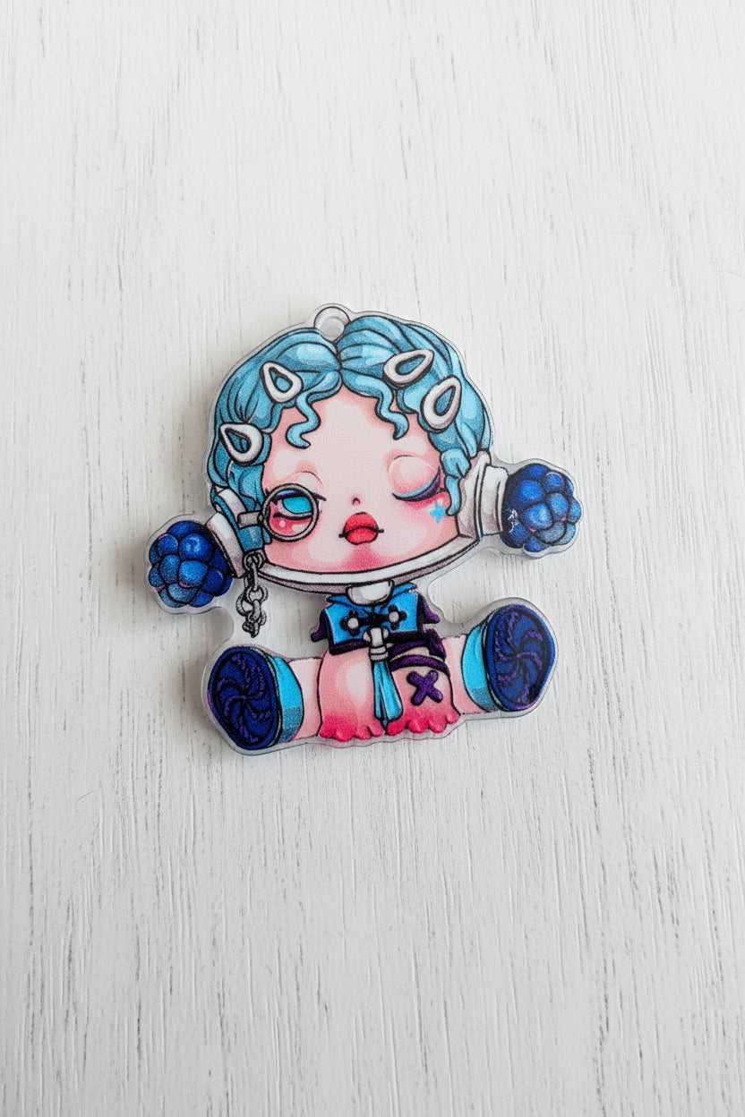 A colorful acrylic bead of a cute anime-style character with blue hair and a pink dress.