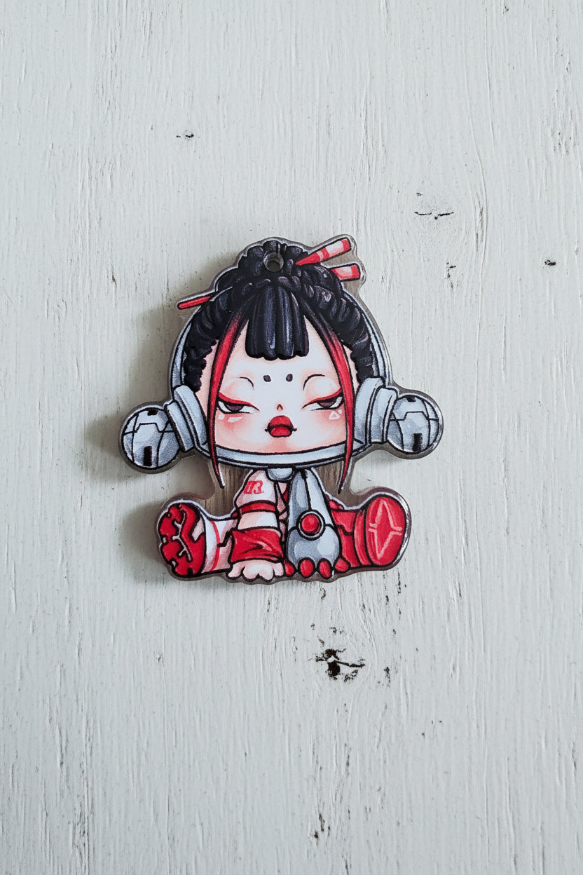 An acrylic bead featuring a stylized anime character with black hair, red and white clothing, and gray mechanical-looking accessories.