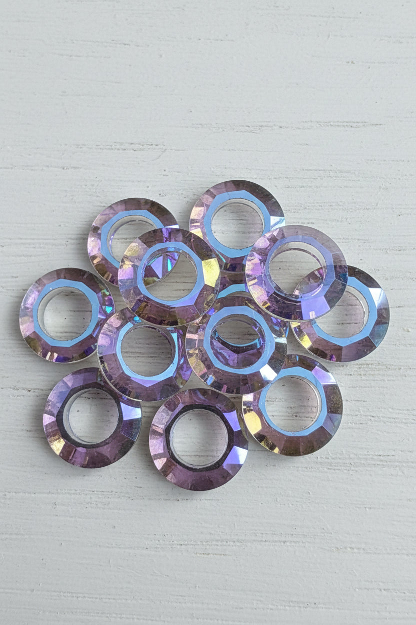 Six faceted round glass beads with an iridescent blue, purple.