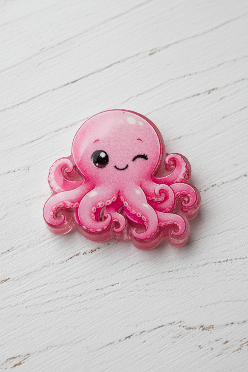A pink octopus bead with a winking face.