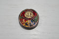 A round acrylic bead with colourful lion crest details and the Hogwarts 'H' logo.