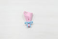 A metal shaped like a pink flower bouquet tied with a light blue ribbon.