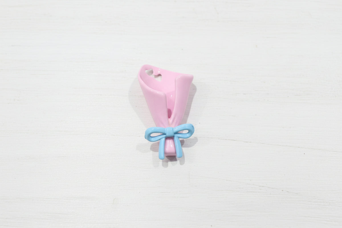 A metal shaped like a pink flower bouquet tied with a light blue ribbon.