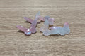 iridescent butterfly-shaped beads with a pink, purple, and blue color-shifting sheen.