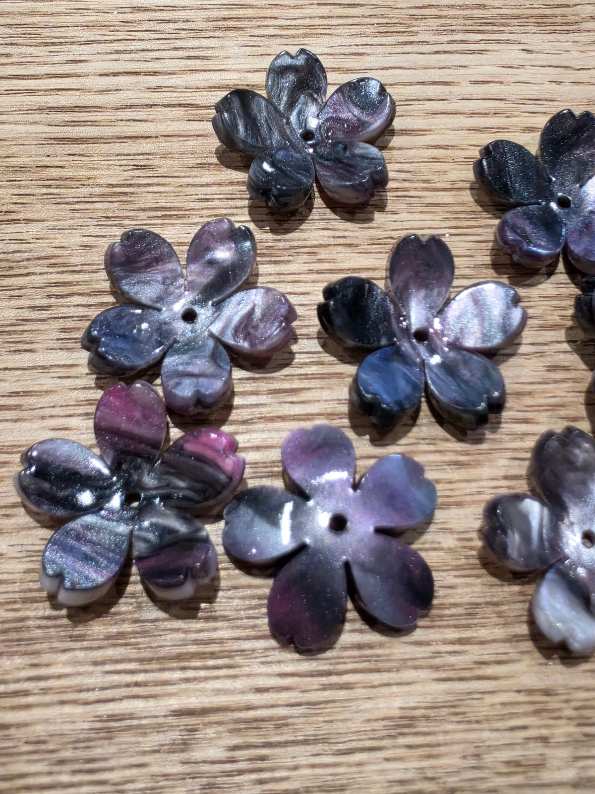 flower-shaped beads with a glossy, marbled purple, black.