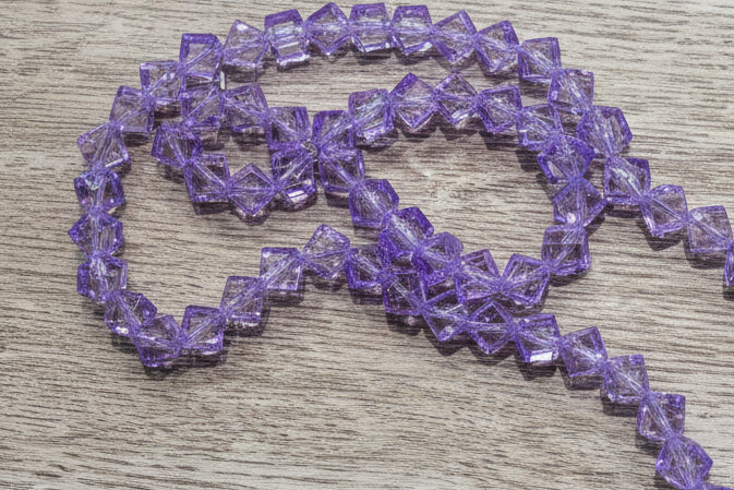 A strand of purple glass beads.