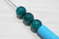 Glossy resin beads.