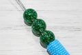 16mm resin beads filled with iridescent glitter.