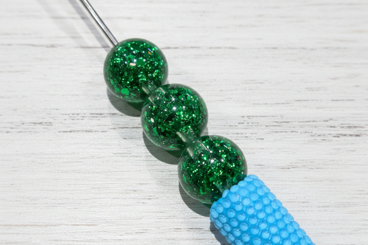 16mm resin beads filled with iridescent glitter.
