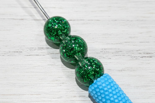 16mm resin beads filled with iridescent glitter.