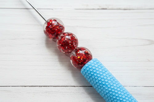 16mm red resin round beads filled with red glitter.