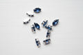 zircon beads perfect for jewellery scattered on a wood surface.