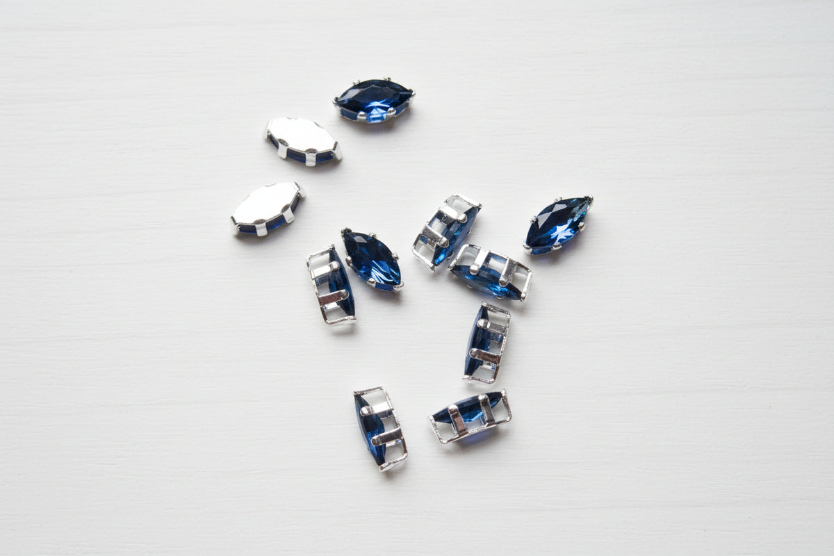 zircon beads perfect for jewellery scattered on a wood surface.
