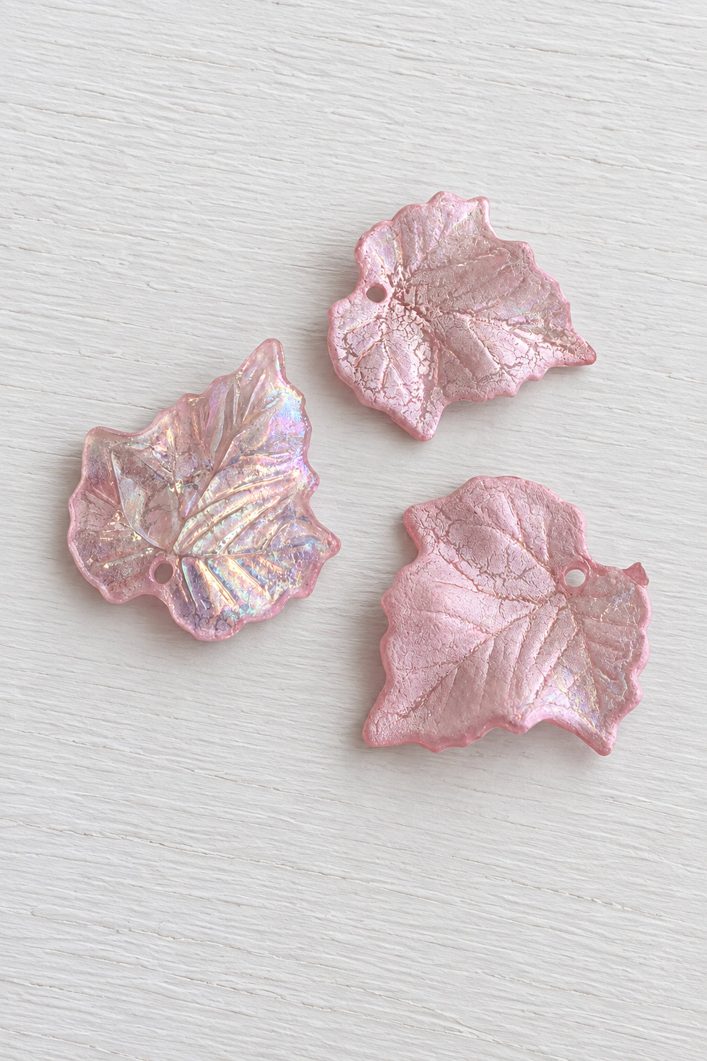 Pink acetate leaves  with one piece showing a subtle iridescent shimmer.