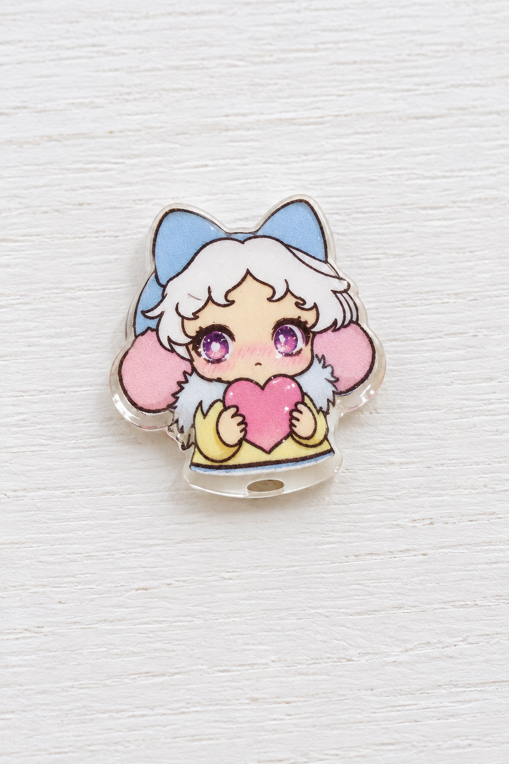A small metal bead featuring a cute anime-style character with white hair, blue cat ears, pink cheeks, and a pink heart.