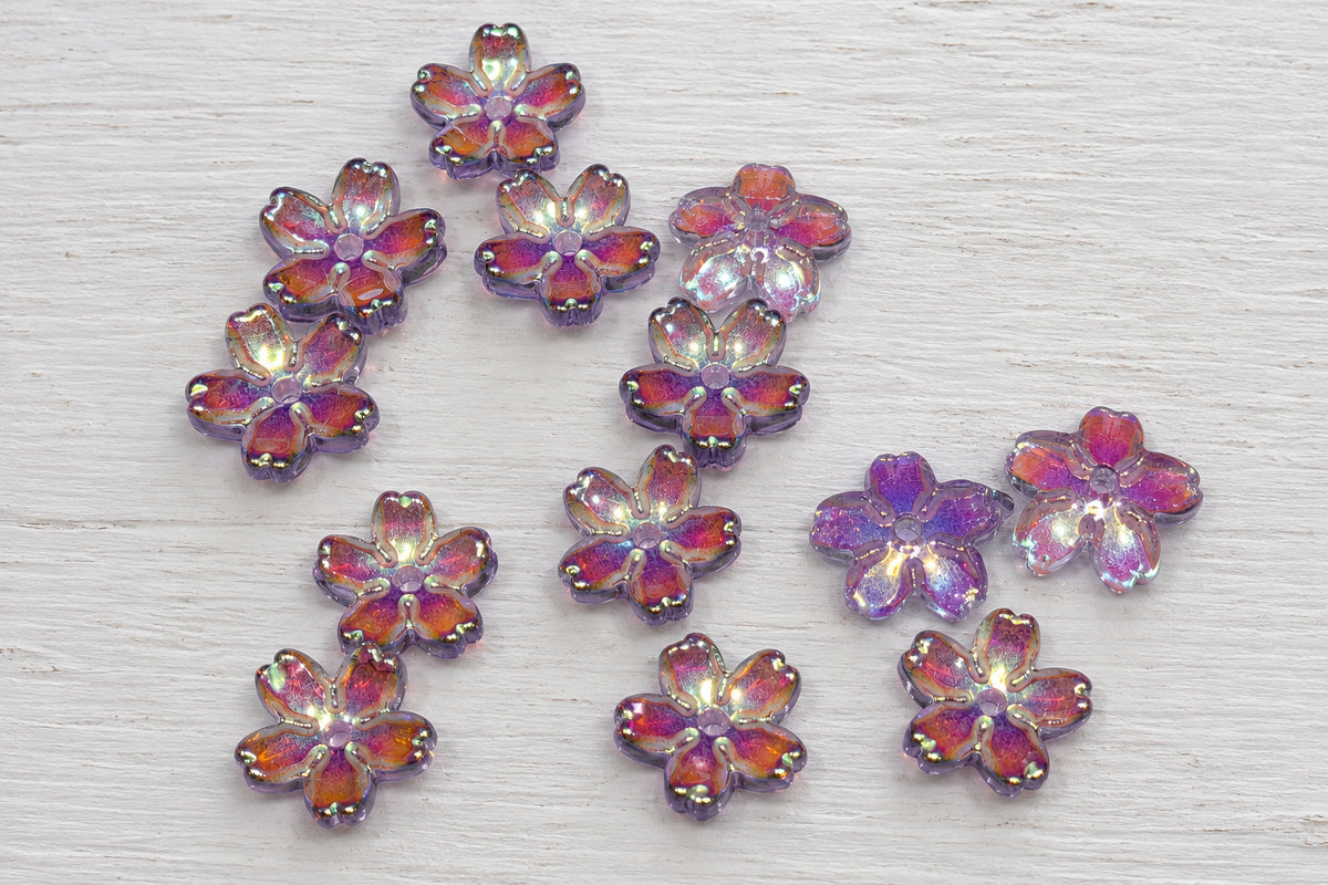 Small glass flower-shaped beads with iridescent purple petals.