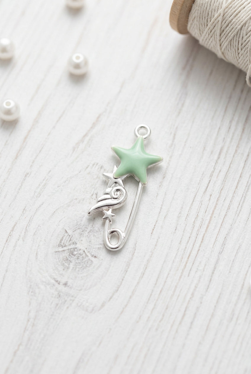pin shaped charm with star and wing detail