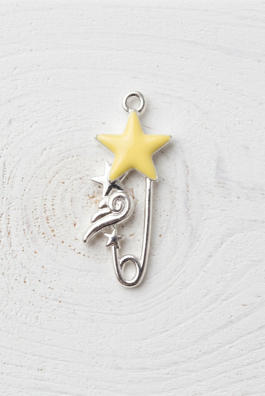 pin shaped charm with star and wing detail