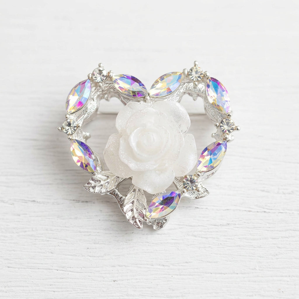 A heart-shaped silver-toned bead featuring a central white rose surrounded by iridescent zircon accents.