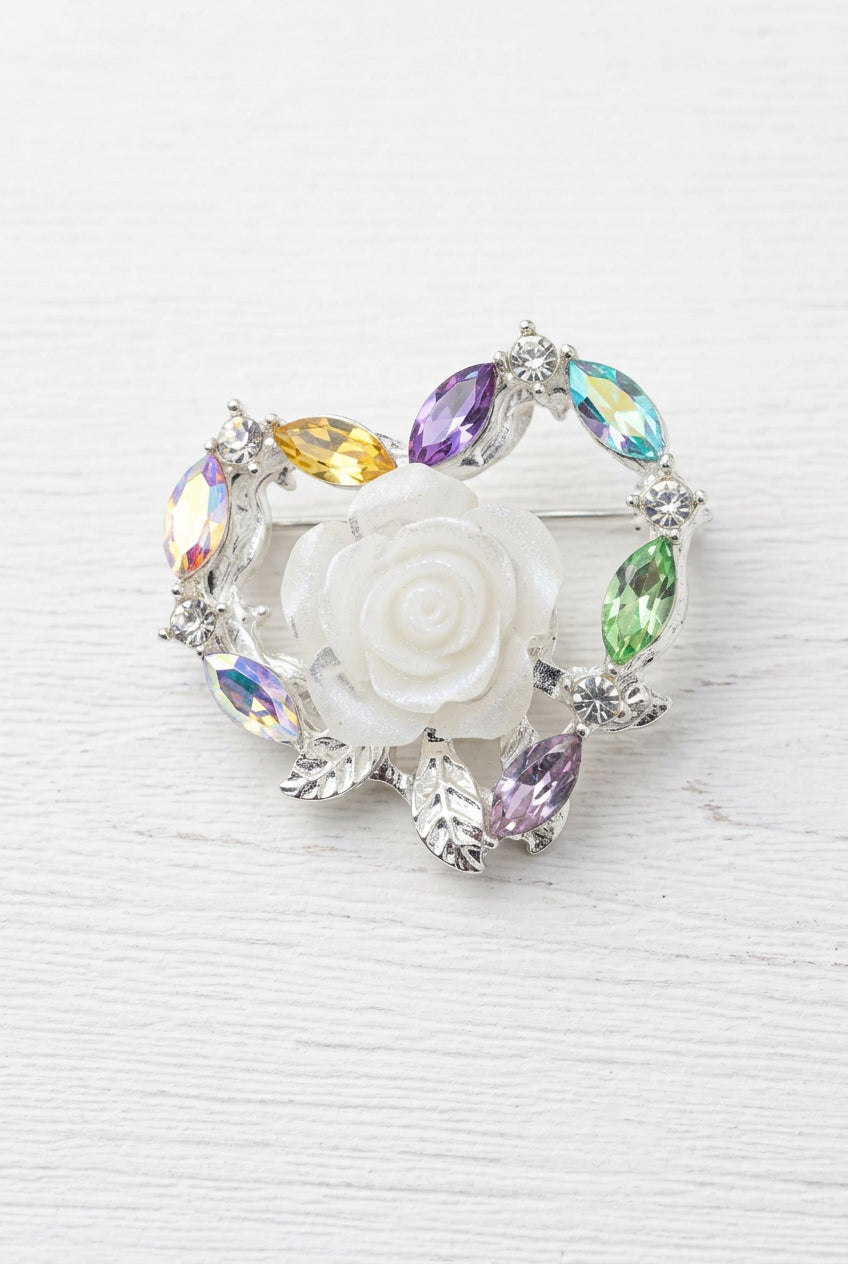 A heart-shaped silver-toned bead featuring a central white rose surrounded by iridescent zircon accents.