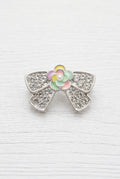 A silver bow-shaped bead with a colorful enamel flower centre.